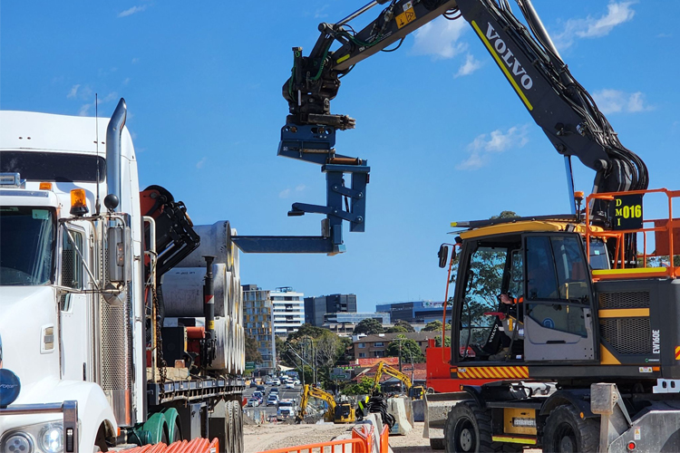 Pipe lifting attachment on excavator