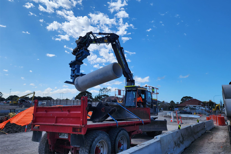 Pipe lifting attachment on excavator