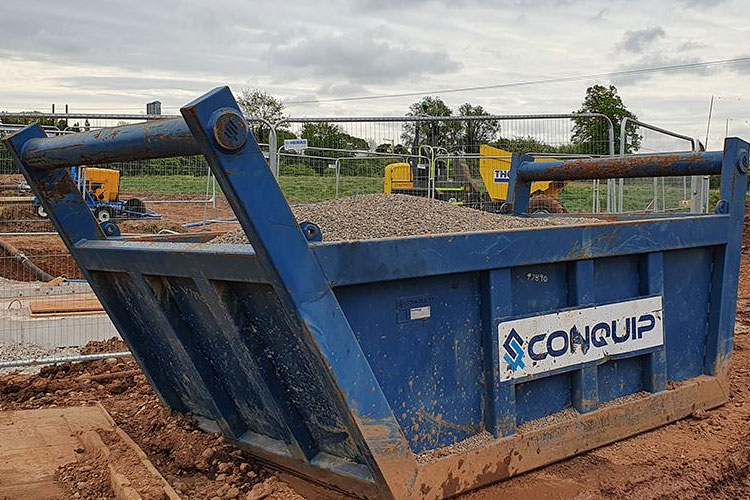 Blue Conquip Excavator Drag Skip on site filled with shingle