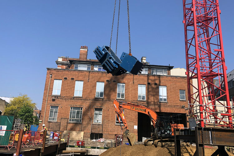 Blue Conquip waling beam parts crane lifted across site at Royal Brompton Hospital