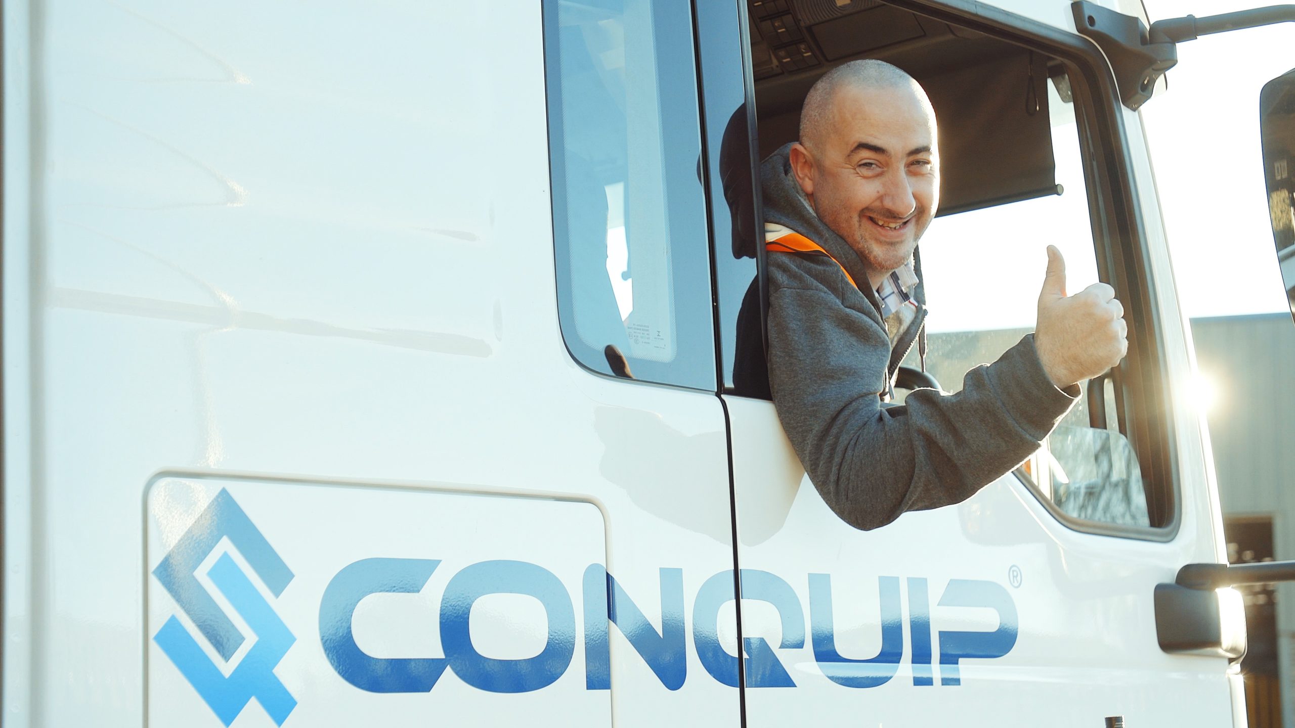 Conquip driver giving thumbs up out of lorry window for our FORS Gold Transport Service