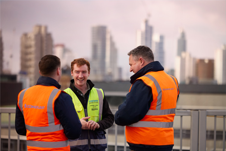 Men is High visibility tops talking and laughing
