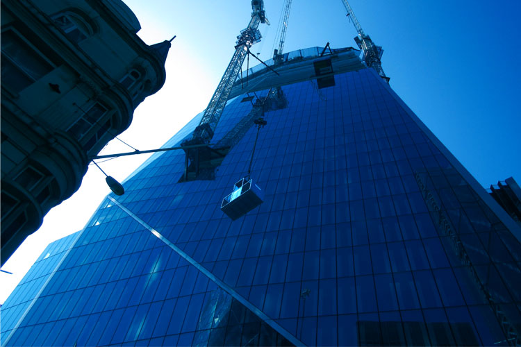Conquip Rescue Cage on a crane being lifted up a tall building
