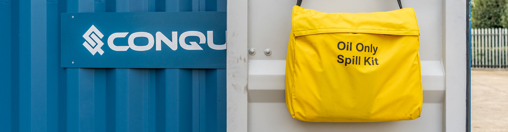 A Conquip Maintenance Spill Kit hanging on a Fuel Eco-Hub door.