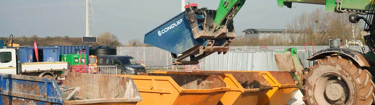 A Conquip Autolock Tipping Skip being tipped by a Telehandler