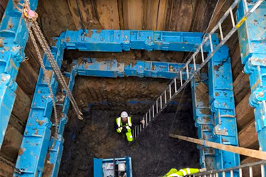 A man in a hole looking up supported by a Conquip 300 Brace