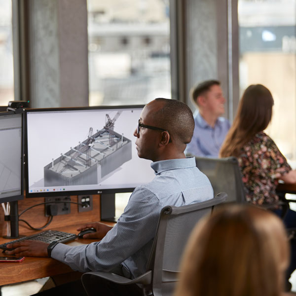 A man using a computer for construction design.