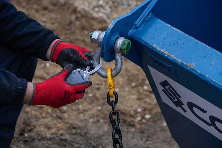 Man tagging a concrete skip