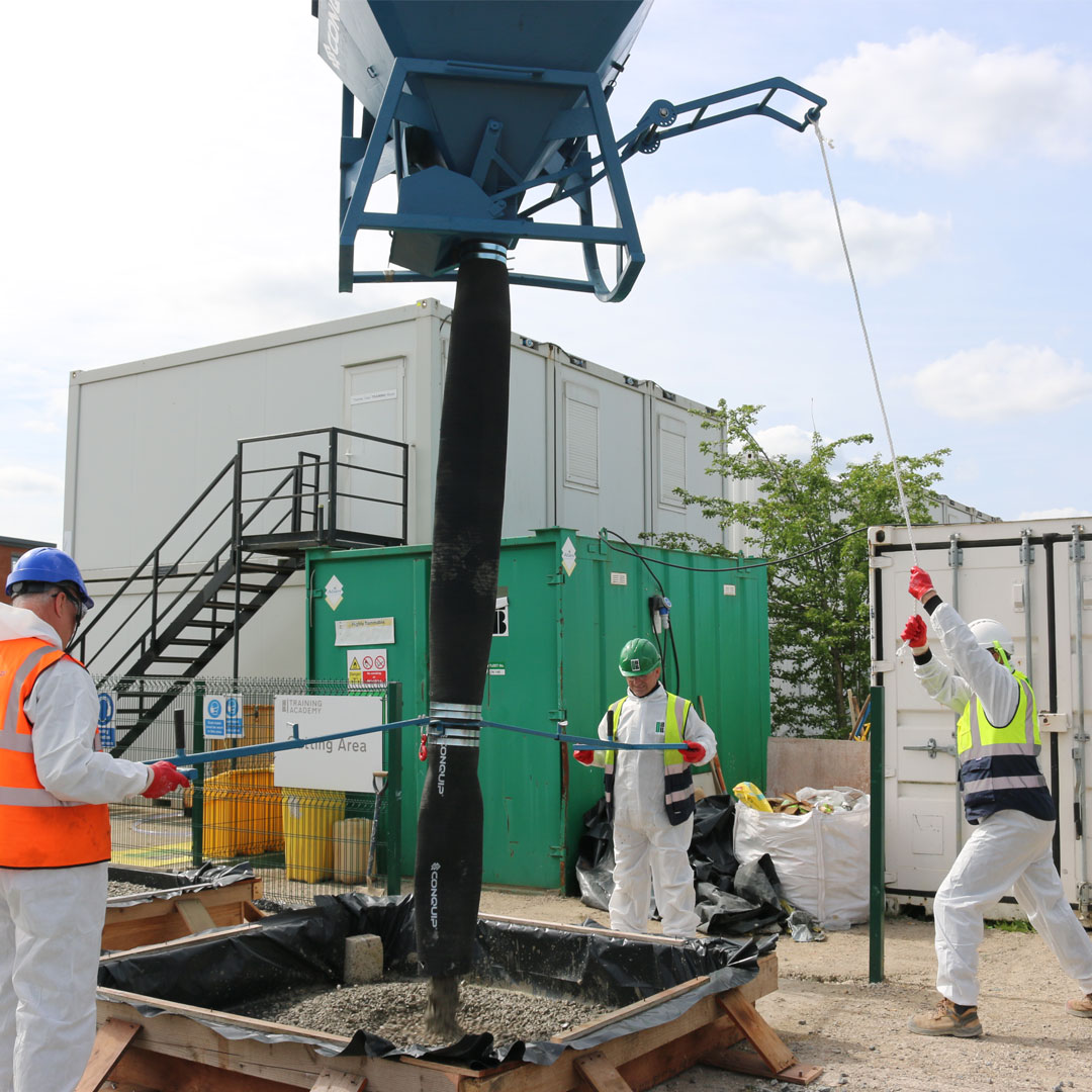 Conquip Extended Flow Gate Handle for Concrete Skip being used by operatives.