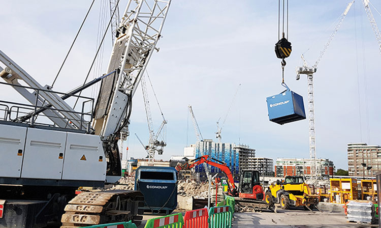 Crane Forks cage lifted with a crane in a busy construction site