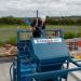 A man on top of a Conquip Concrete Washout System