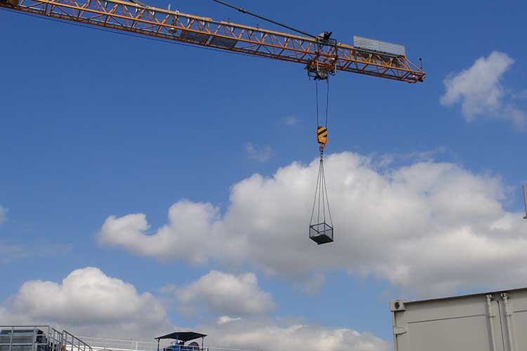 crane lifted goods cage by conquip