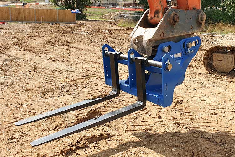 excavator forks mounted on excavator on a development site